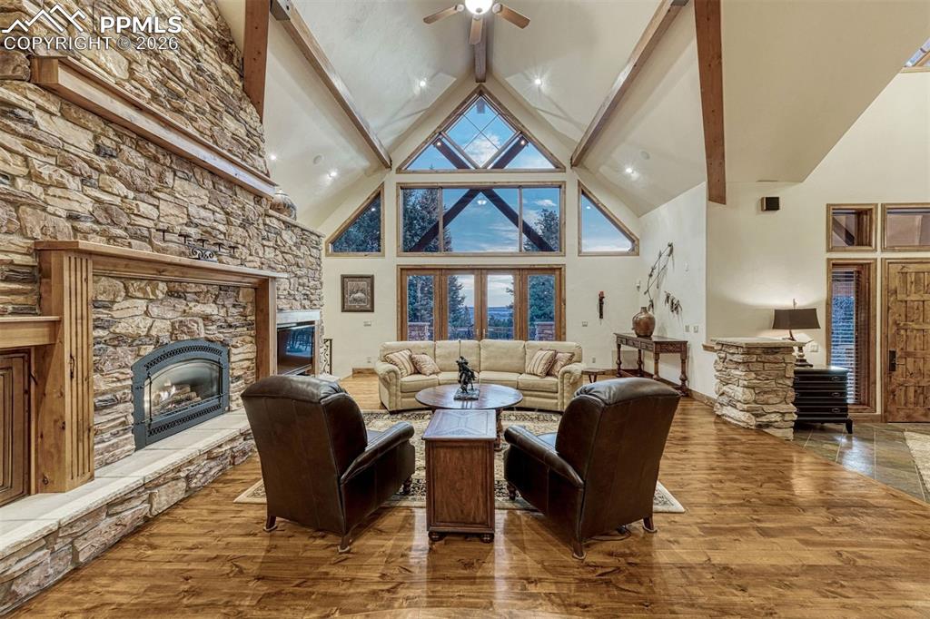 Image 3 of 50: Sunlit great room with rich hardwood floors and views