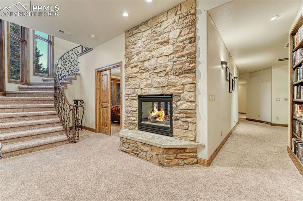 Image 37 of 50: A sunlit stairway gracefully connecting to the lower level