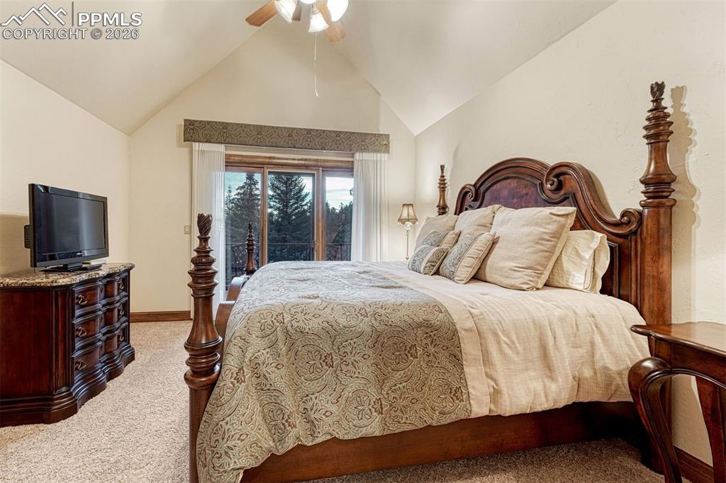 Image 41 of 50: Upper-level bedroom with private balcony and scenic outlook.