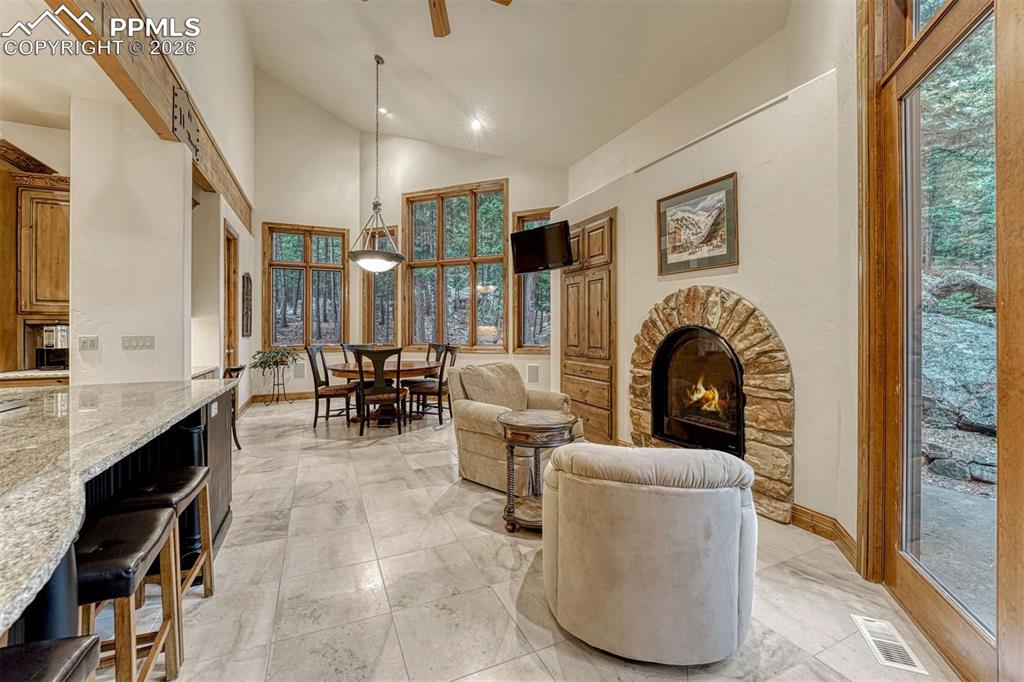 Image 44 of 50: Cozy sitting hearth area near the kitchen.