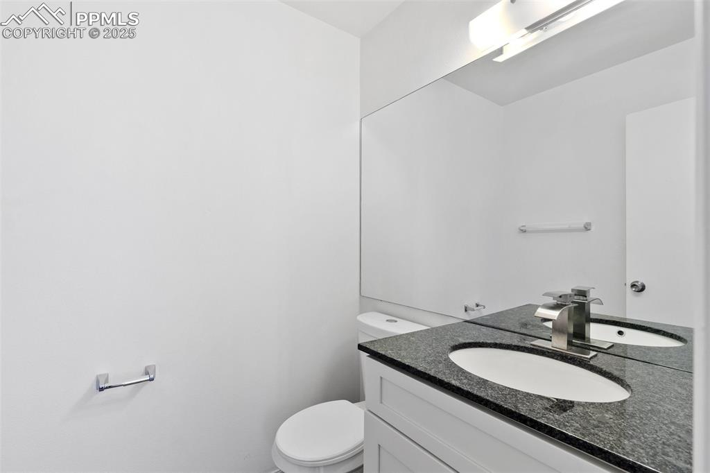 Image 8 of 23: Half bathroom with toilet and vanity