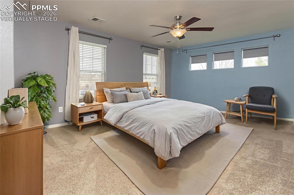 Image 11 of 33: Bedroom featuring a ceiling fan and light carpet Virtually Staged