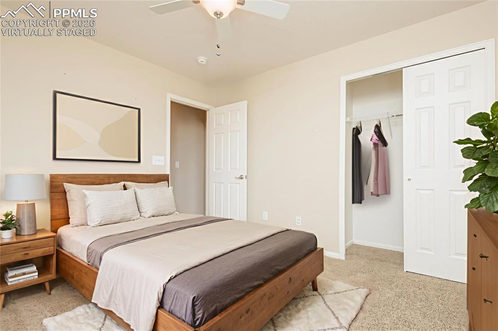 Image 15 of 33: Bedroom featuring light colored carpet, a ceiling fan, and a closet Virtual