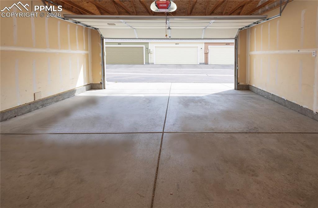 Image 20 of 33: Garage featuring a garage door opener