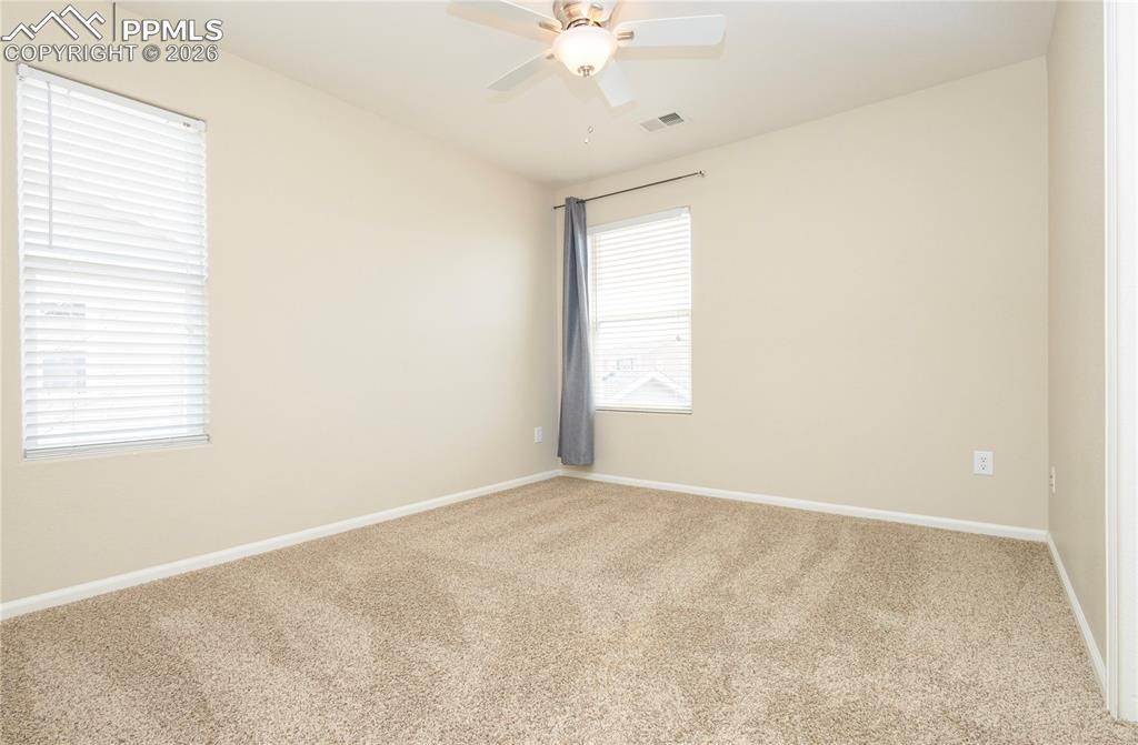 Image 22 of 33: Carpeted empty room with baseboards and a ceiling fan