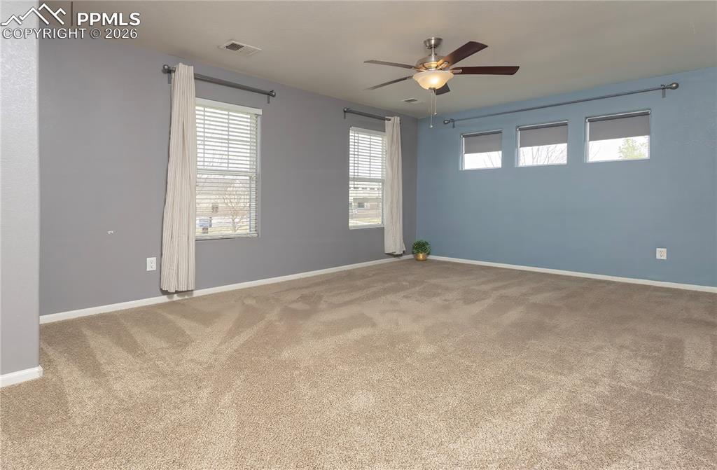 Image 25 of 33: Spare room with ceiling fan and light carpet