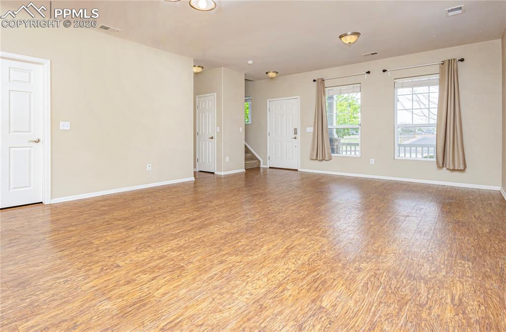Image 32 of 33: Spare room with light wood-style flooring and baseboards