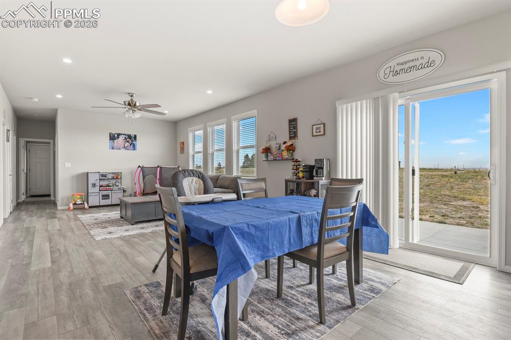 Image 13 of 48: Dining area with wood-finish flooring, recessed lighting, and a ceiling fan