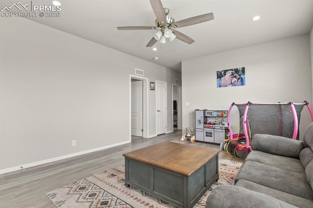 Image 16 of 48: Living area featuring recessed lighting, a ceiling fan, and wood-finish flo