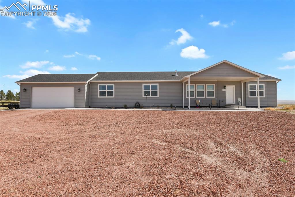 Image 2 of 48: Ranch-style exterior with gray horizontal siding and a dark shingle roof