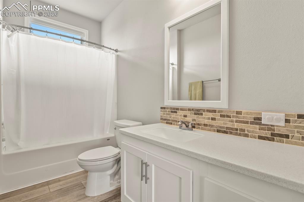 Image 24 of 48: Bathroom featuring a white vanity with integrated sink, a rectangular frame