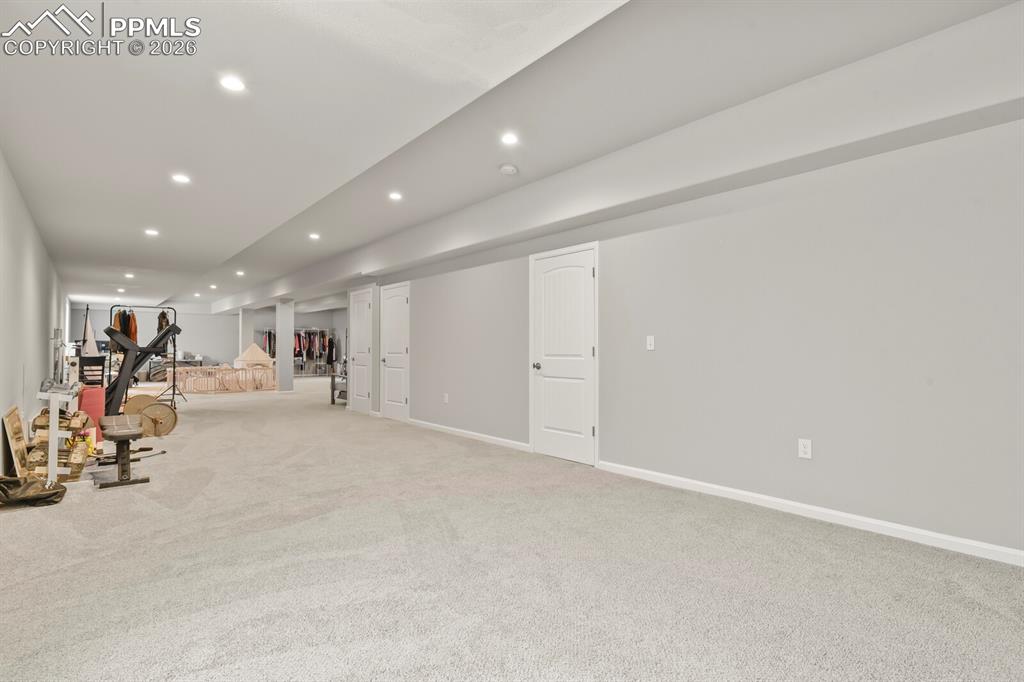 Image 30 of 48: Spacious carpeted room featuring recessed lighting, light gray painted wall
