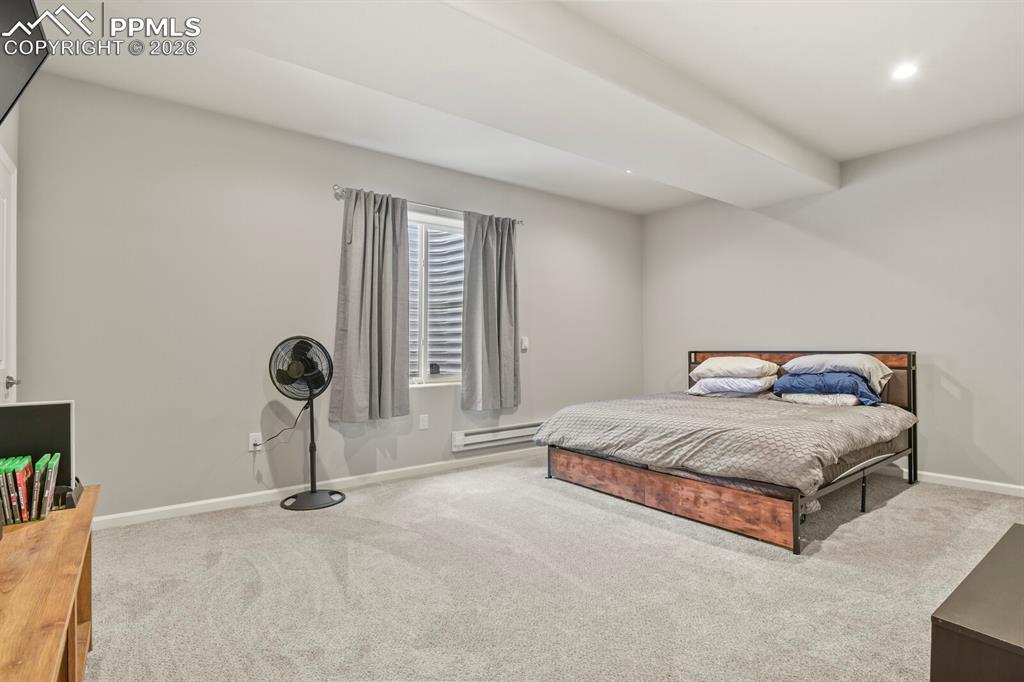 Image 31 of 48: Carpeted room featuring light gray walls, a window with horizontal blinds a