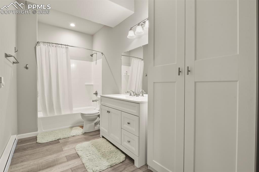 Image 33 of 48: Bathroom featuring a white vanity with a rectangular sink, a mirrored medic