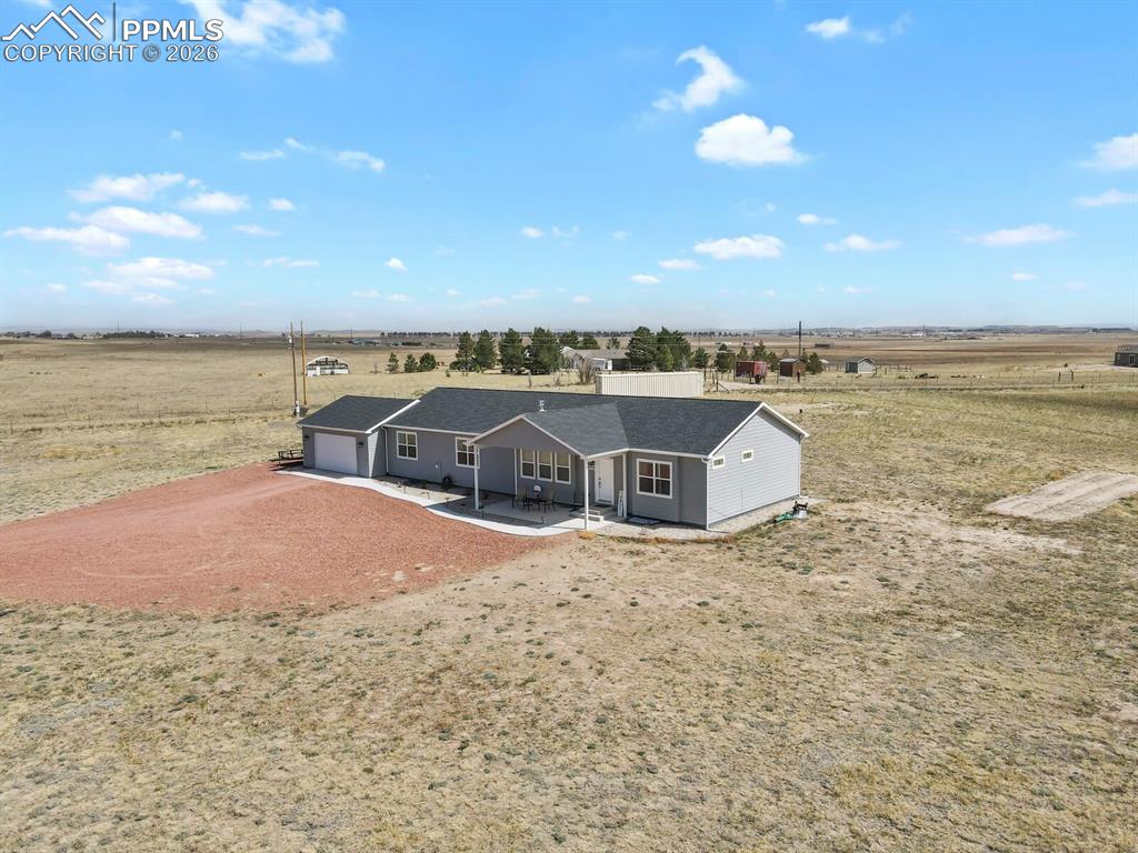 Image 39 of 48: Ranch-style exterior with light gray siding, dark shingle roof, attached ga