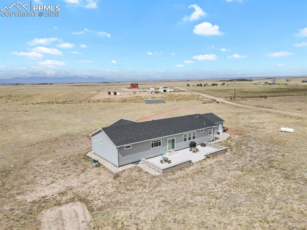 Image 40 of 48: Ranch-style residence featuring light gray siding and a dark shingle roof