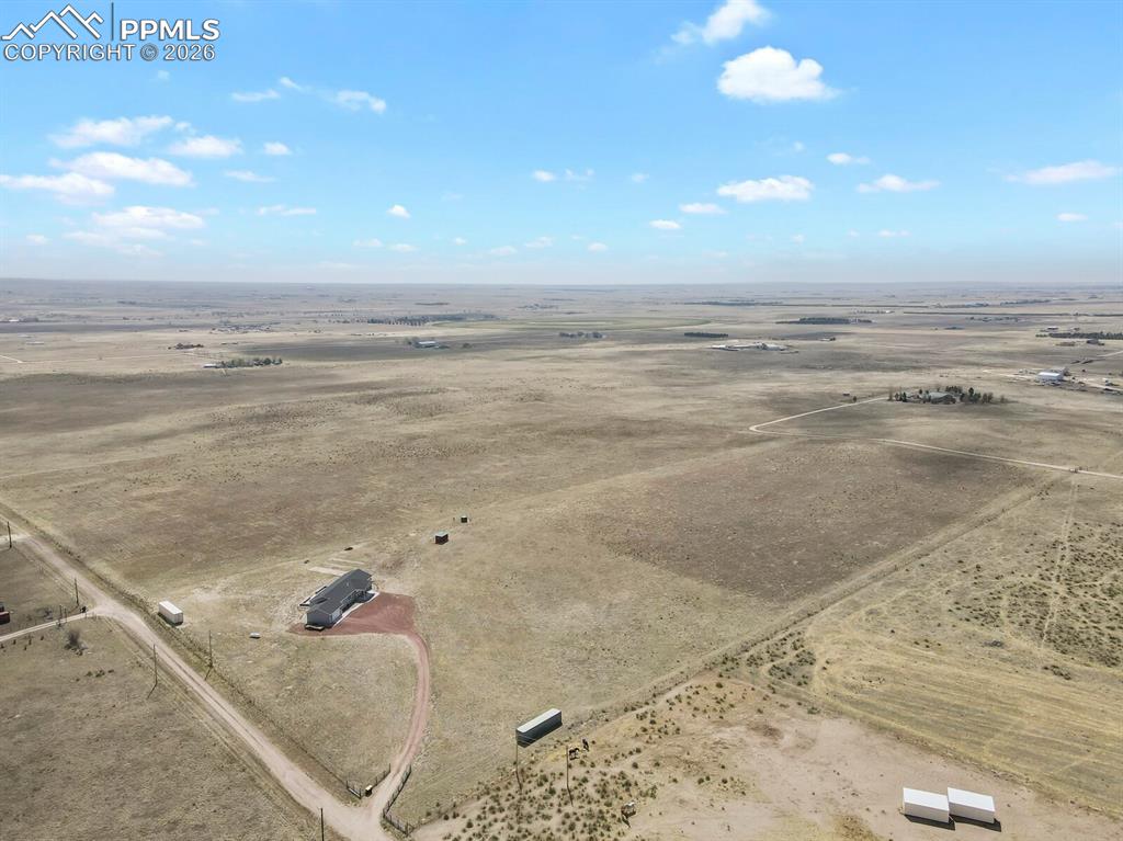Image 42 of 48: Sprawling rural acreage featuring a single-story residence with a dark-tone