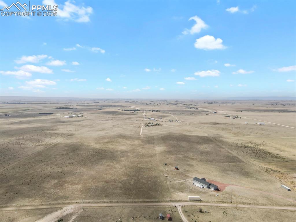Image 43 of 48: Expansive land parcel featuring a contemporary residence with a dark-toned 