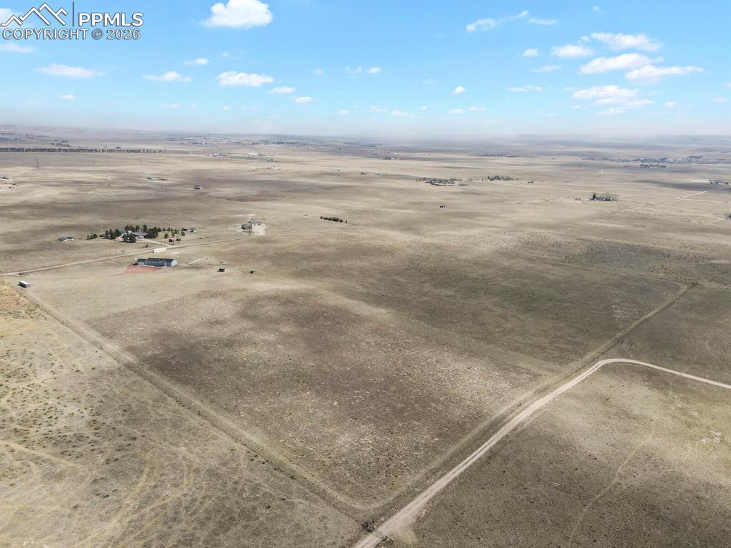 Image 47 of 48: Expansive open landscape featuring a single-story building, an accompanying