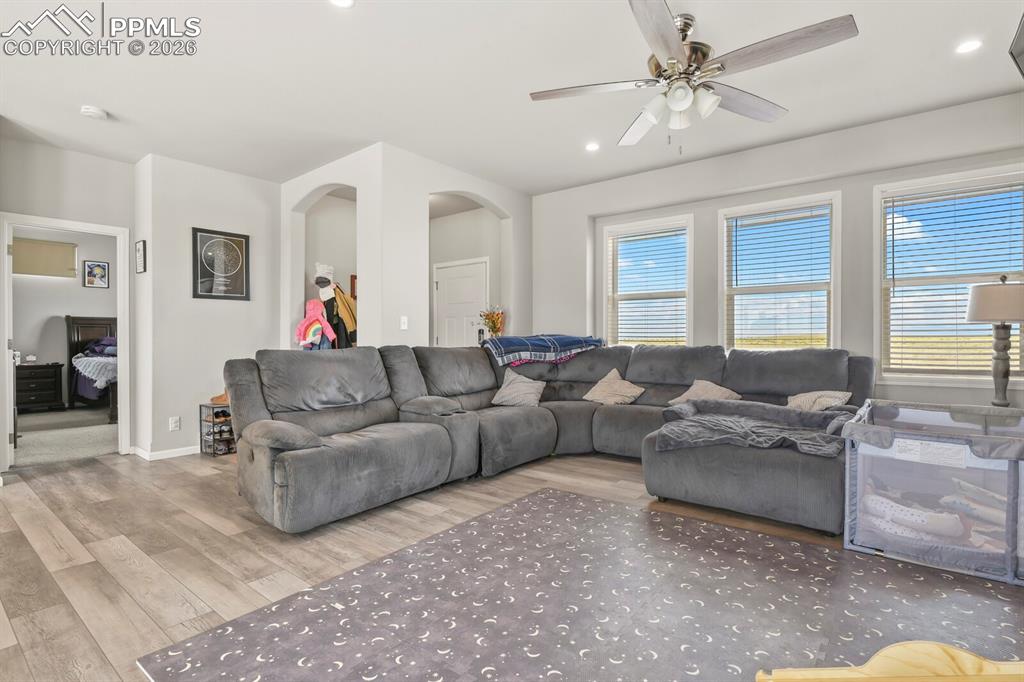 Image 5 of 48: Spacious living area featuring light wood-finish flooring, recessed lightin