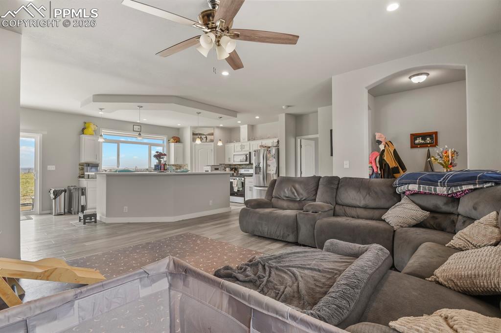 Image 6 of 48: Open-concept living area featuring light wood-finish flooring and neutral g