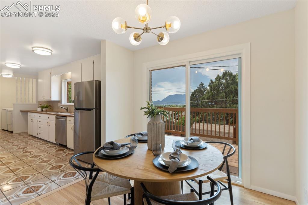 Image 10 of 37: New sliding glass door to the rear deck with mountain views.