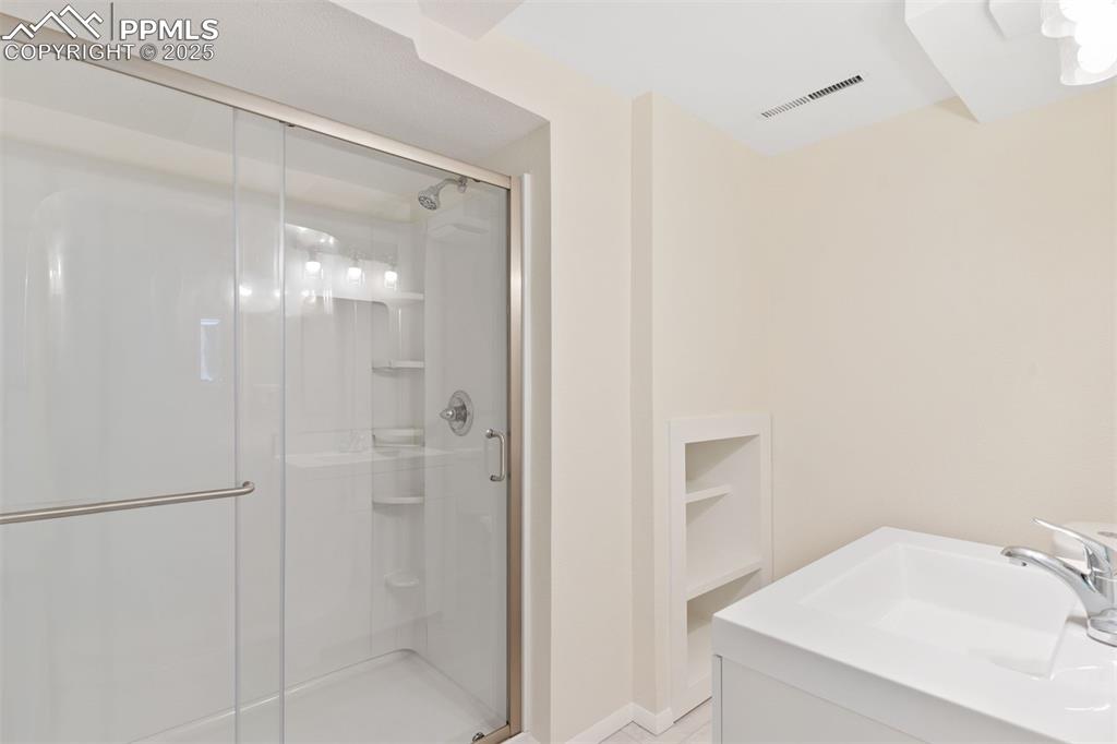 Image 27 of 37: Fully renovated basement bathroom.