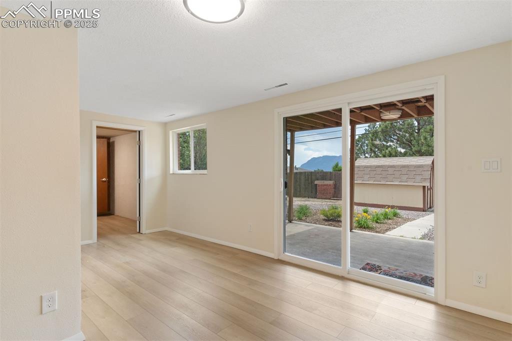 Image 28 of 37: New LVP flooring and sliding glass door.