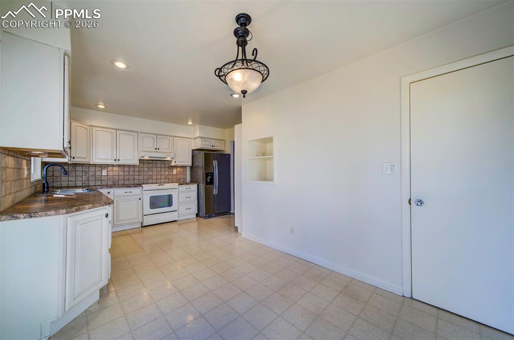 Image 11 of 40: View from patio door, into kitchen from dining room area