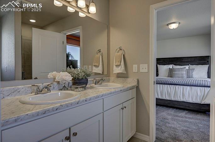 Image 21 of 21: Bathroom with double vanity, ensuite bathroom, and a shower stall