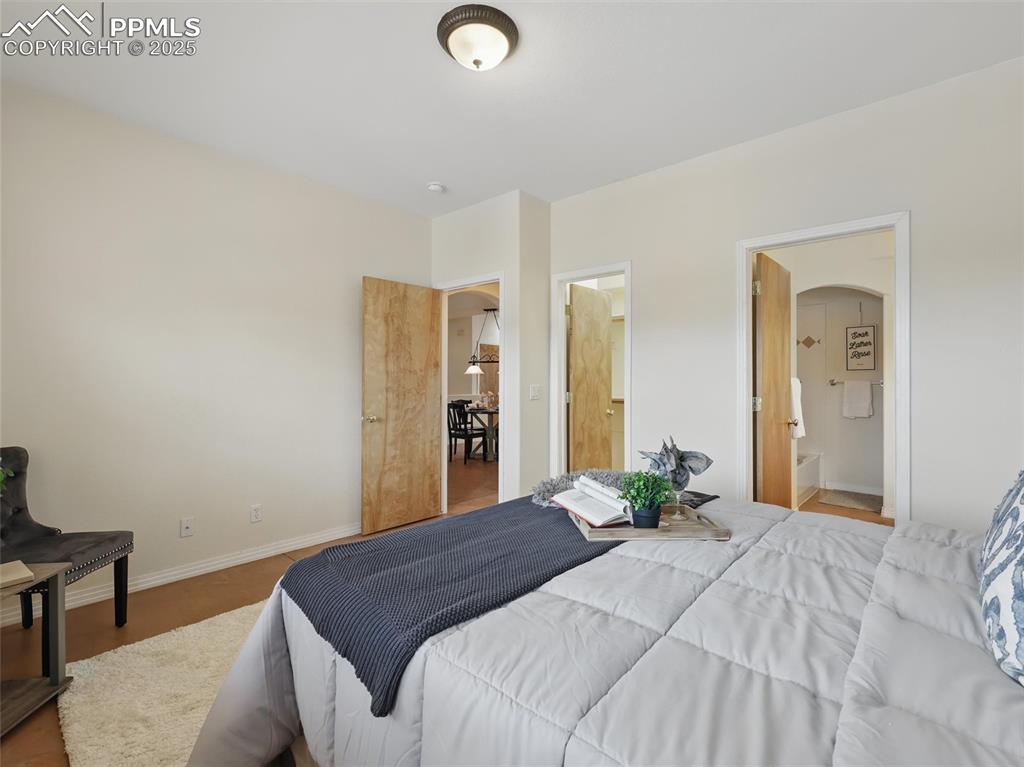 Image 14 of 41: Bedroom featuring ensuite bathroom and arched walkways