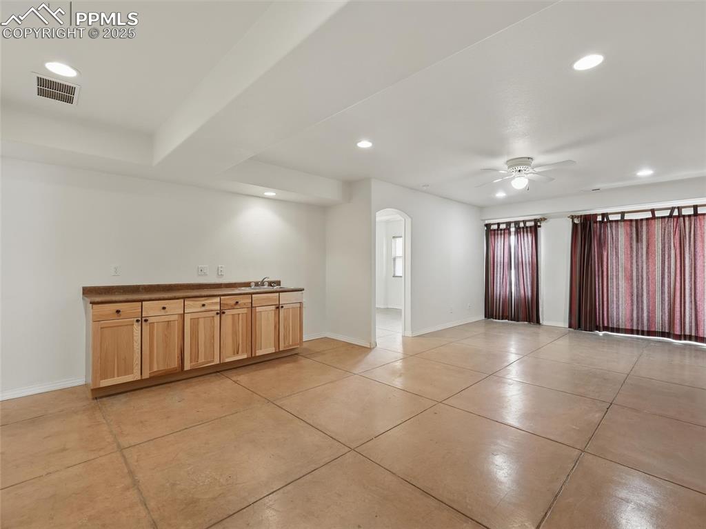 Image 23 of 41: Unfurnished room with recessed lighting, arched walkways, a ceiling fan, an