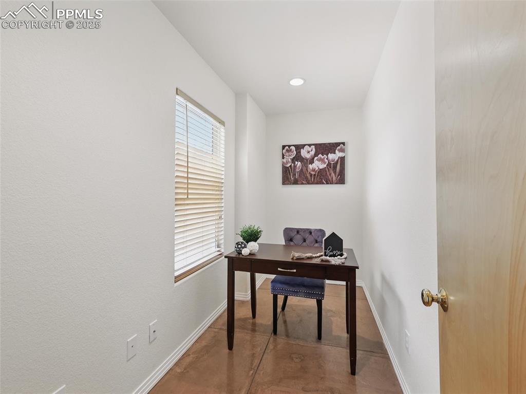 Image 28 of 41: Office space with recessed lighting and concrete flooring