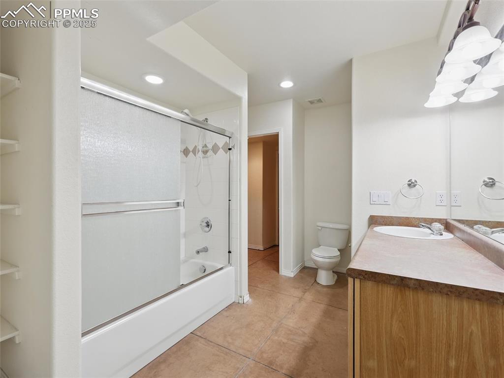 Image 34 of 41: Bathroom featuring light tile patterned flooring, bath / shower combo with 