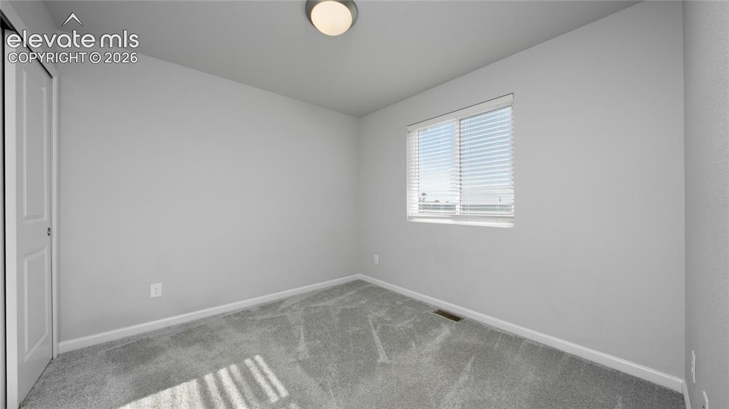 Image 13 of 13: Room featuring light gray carpeting, a single window with horizontal blinds