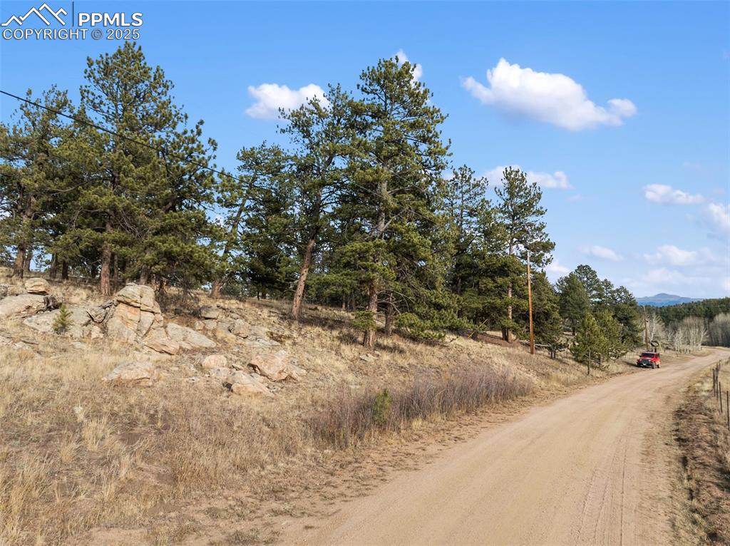 Image 21 of 30: View of dirt / gravel road with a view of rural / pastoral area