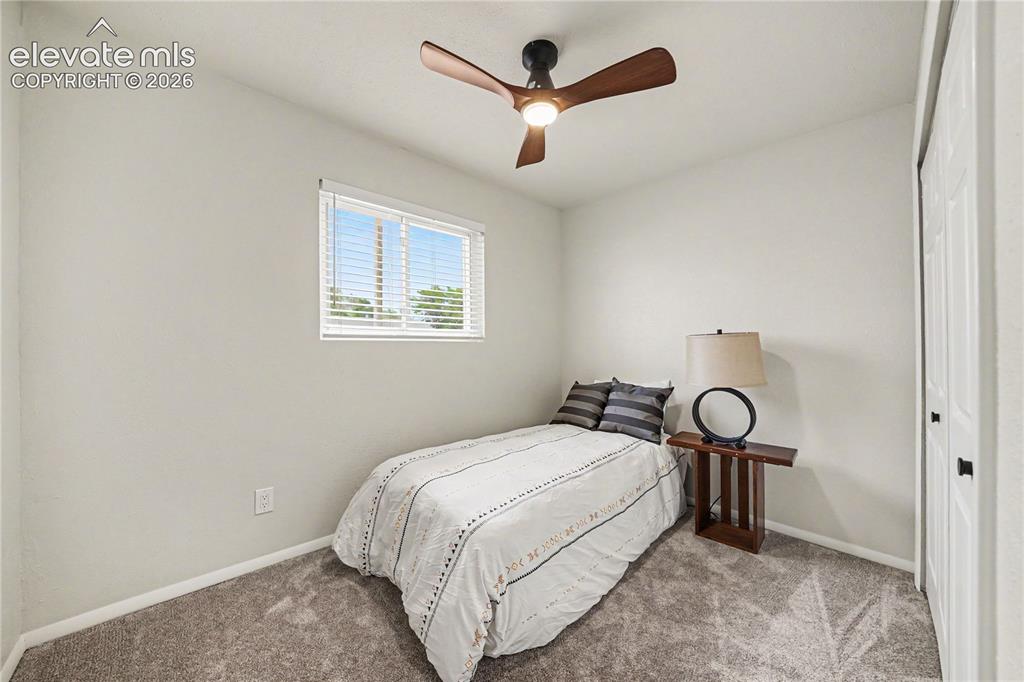 Image 11 of 22: Bedroom #2 Neutral painted walls complemented by plush grey carpeting