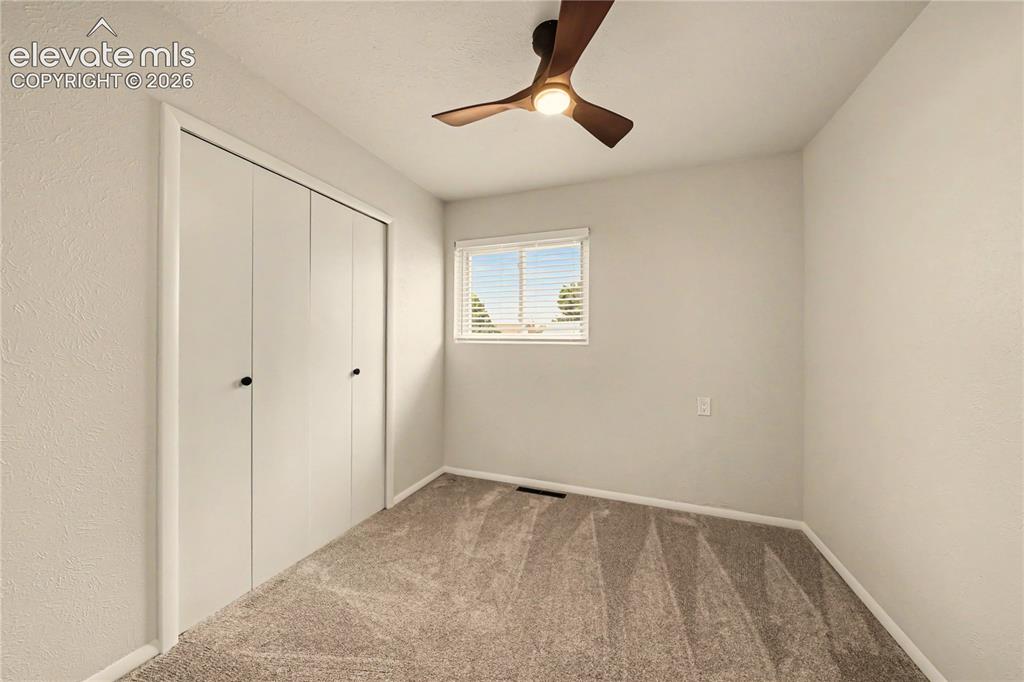 Image 11 of 18: 3rd Bedroom has new carpet, new blinds, new ceiling fan, large closet.