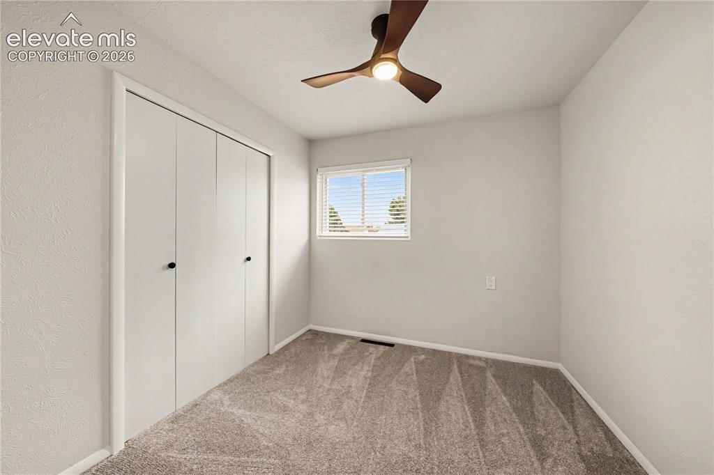 Image 12 of 22: Bedroom #3, featuring neutral-toned walls and carpet flooring