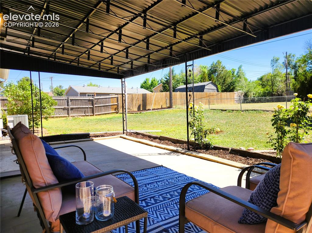 Image 12 of 18: Keep cool under the large covered patio, easily accomodates outdoor living