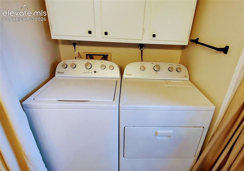 Image 17 of 18: Full size laundry and cabinet storage in Bathroom.