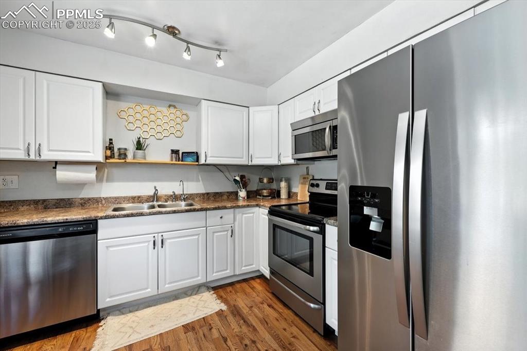 Image 10 of 43: Stainless stee appliances include a smooth top range oven, dishwasher, buil