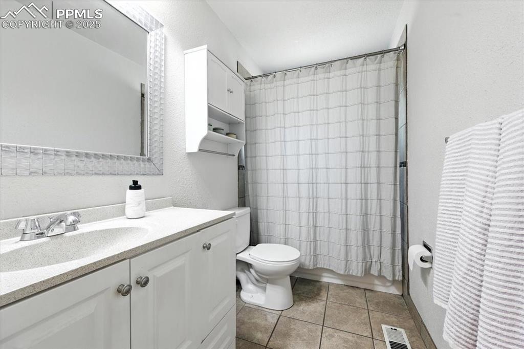 Image 19 of 43: Main Level Full Bathroom featuring vanity, tile patterned flooring