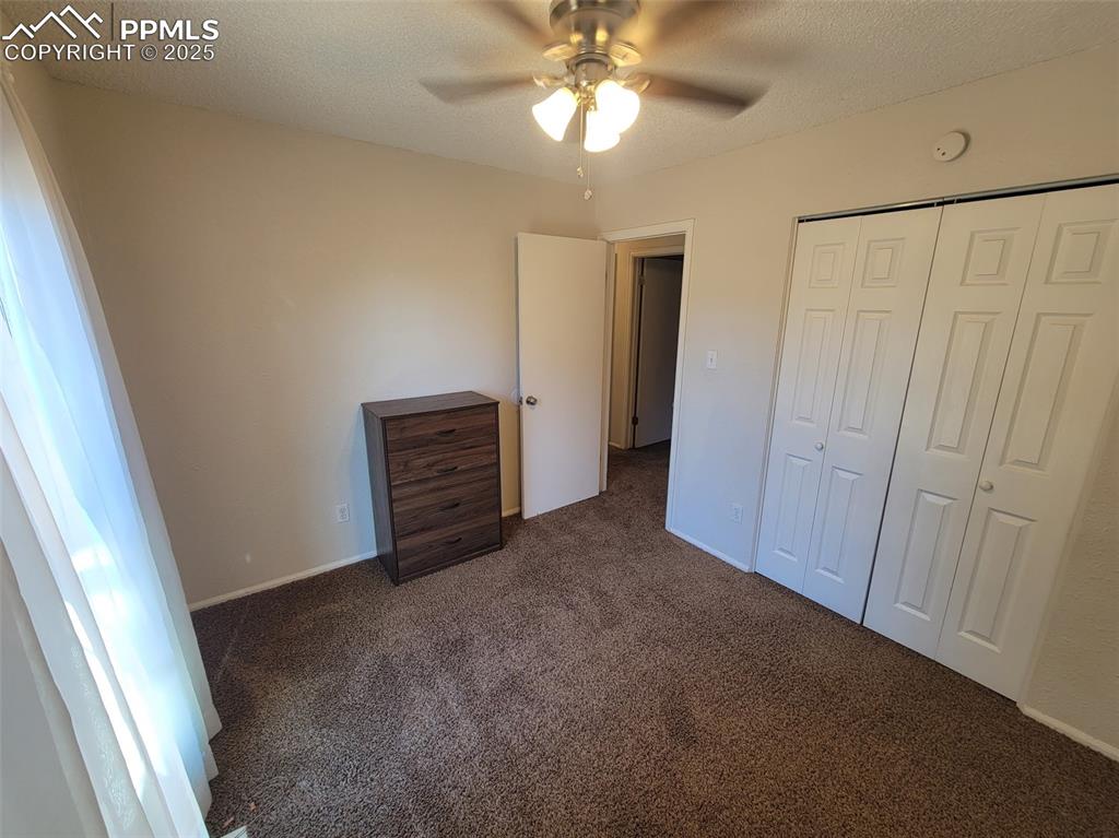 Image 21 of 43: Bedroom #2 View  with Ceiling Fan and 6 panel doors