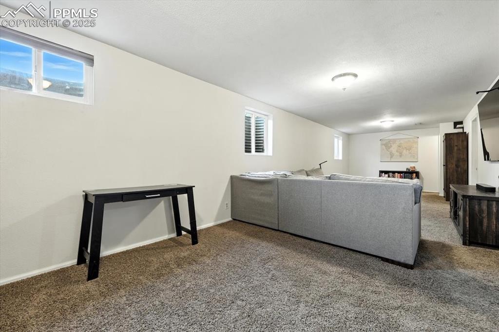 Image 27 of 43: View of the TV area from the office area of the basement.