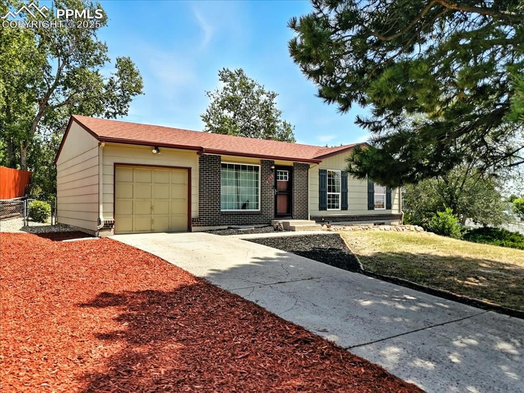 Image 4 of 43: Single story home with an attached garage, concrete driveway with RV parkin