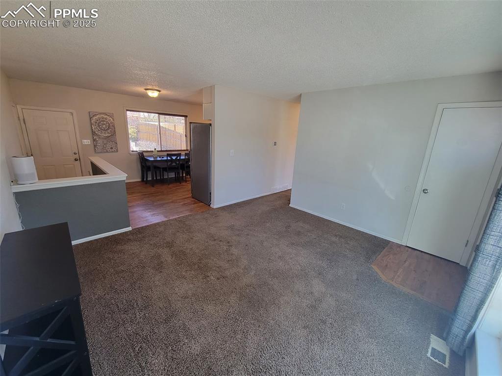 Image 7 of 43: Living Room and Kitchen View