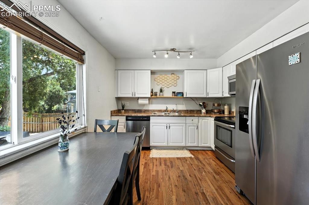Image 9 of 43: Kitchen/Dining Room combo with hardwood floors.