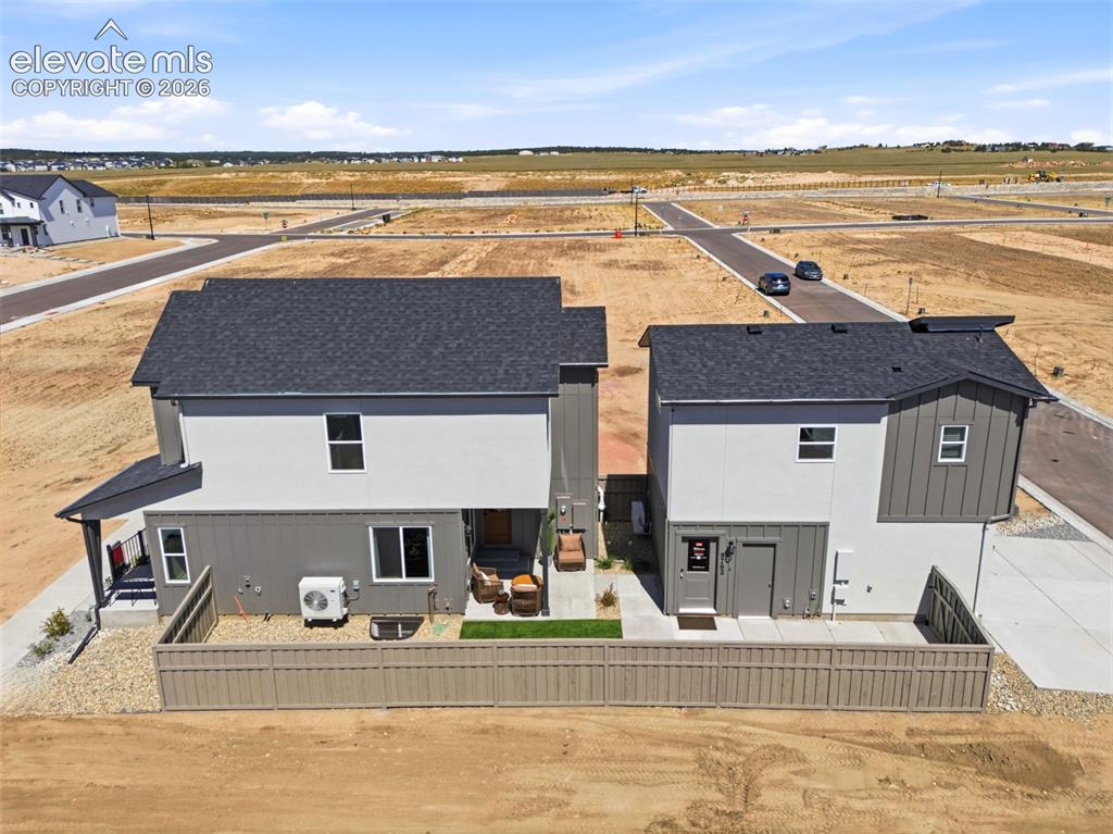 Image 50 of 50: Aerial view of primary home with detached garage and ADU above.