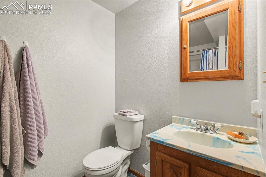 Image 24 of 34: Bathroom featuring a textured wall and vanity